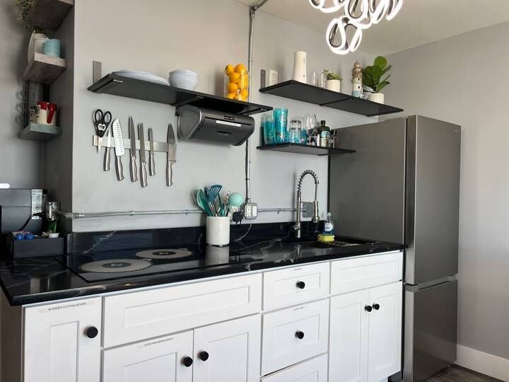 A kitchen with stainless steel appliances and white cabinets