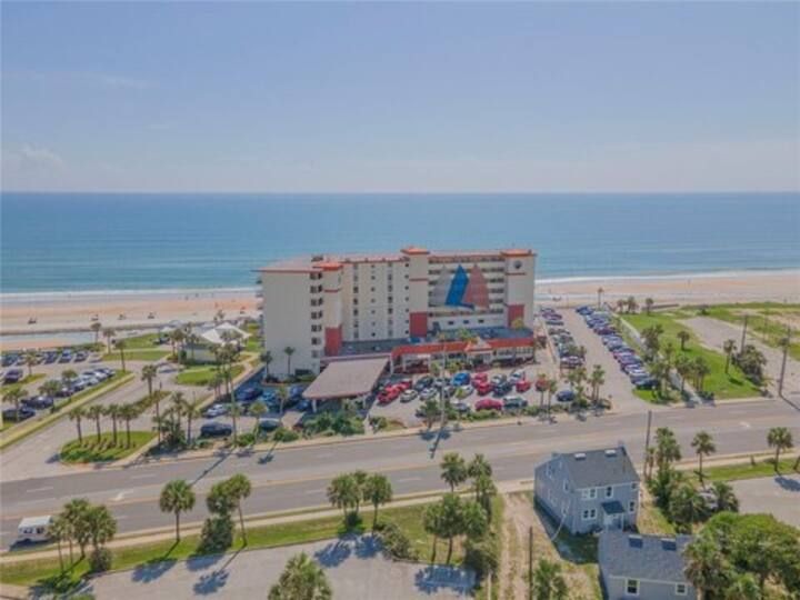 An aerial view of a hotel with a view of the ocean.