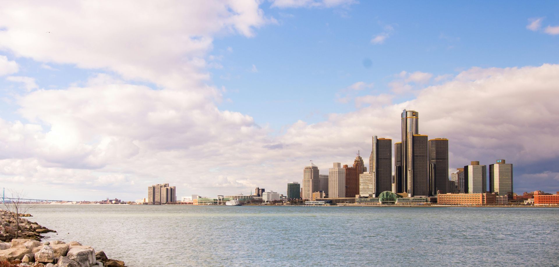 A Detroit skyline is visible over a body of water.