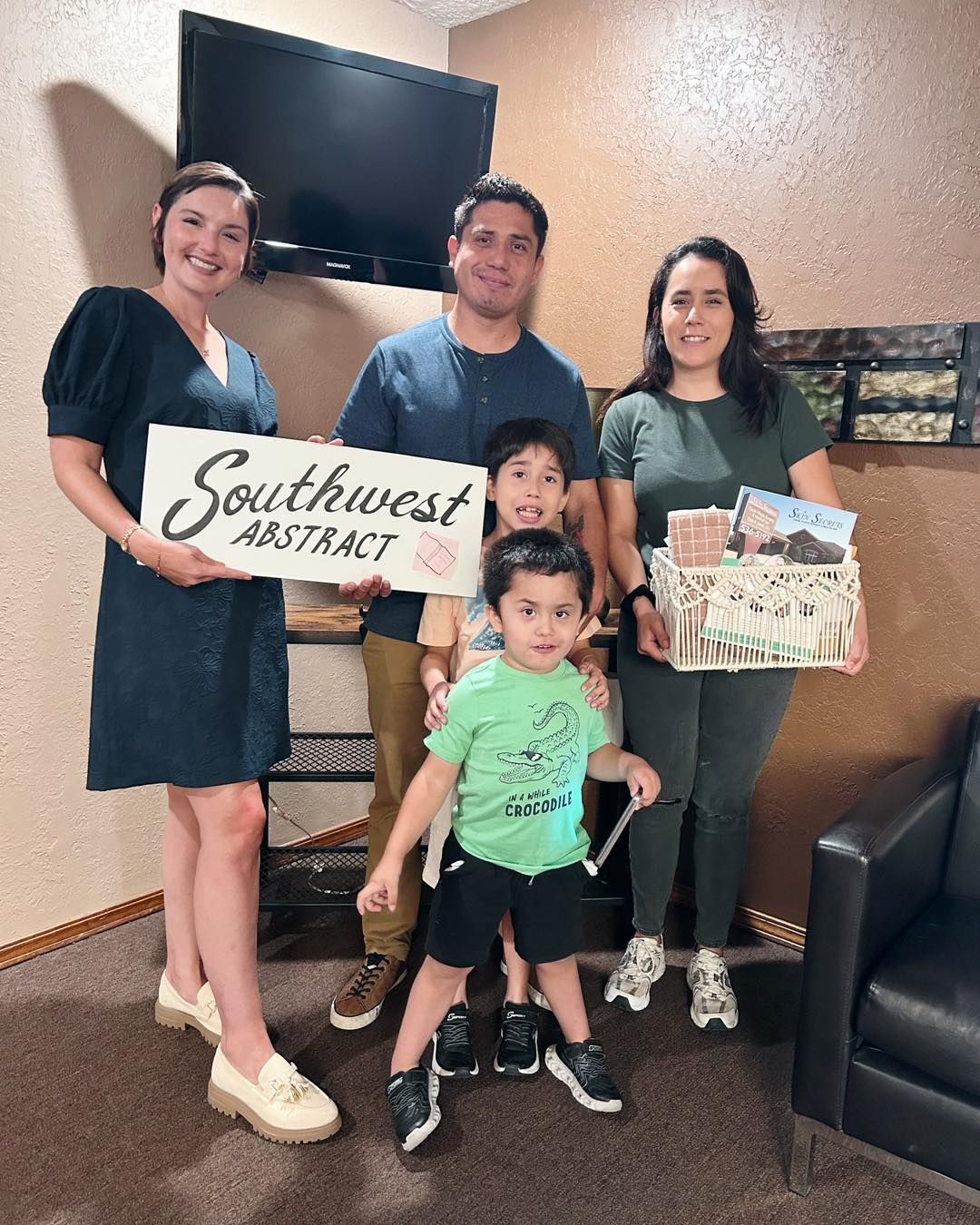 A family and employee pose with a