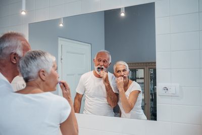 Family Dentist — Old Couple Brushing Their Teeth  in Lexington, NE