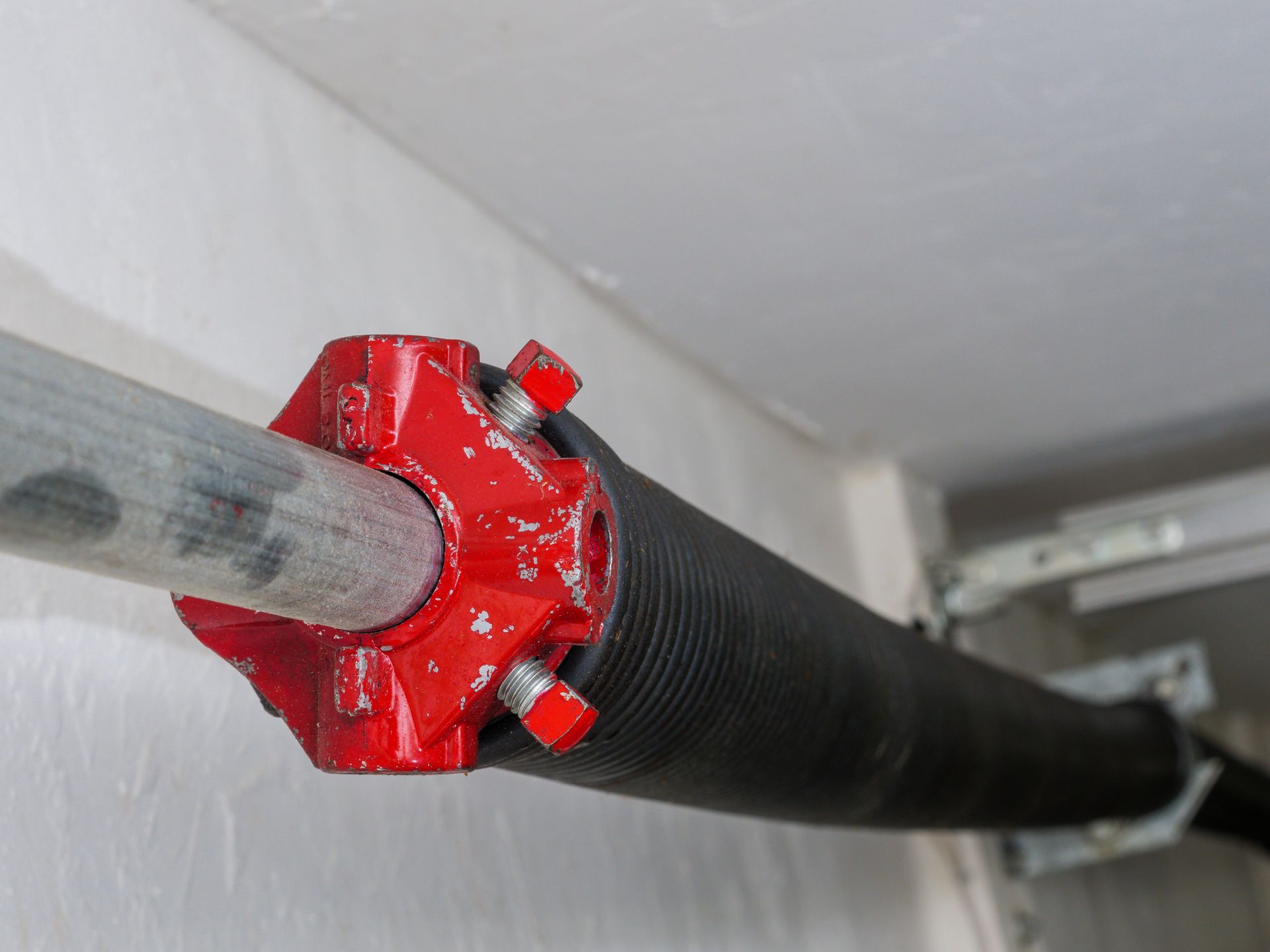 Torsion garage door spring with red winding cone