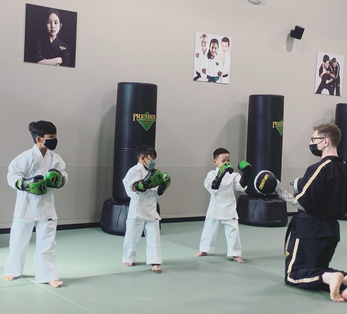 A man and a woman are practicing karate in a gym.