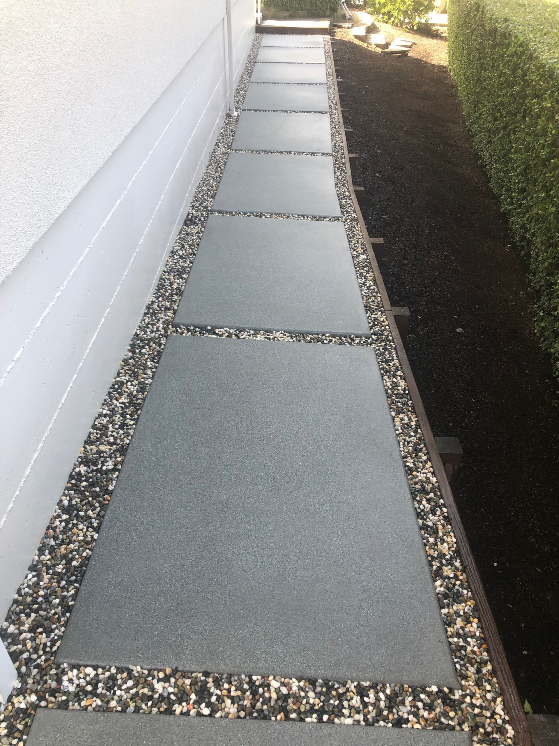 A concrete floor is being poured on a construction site.