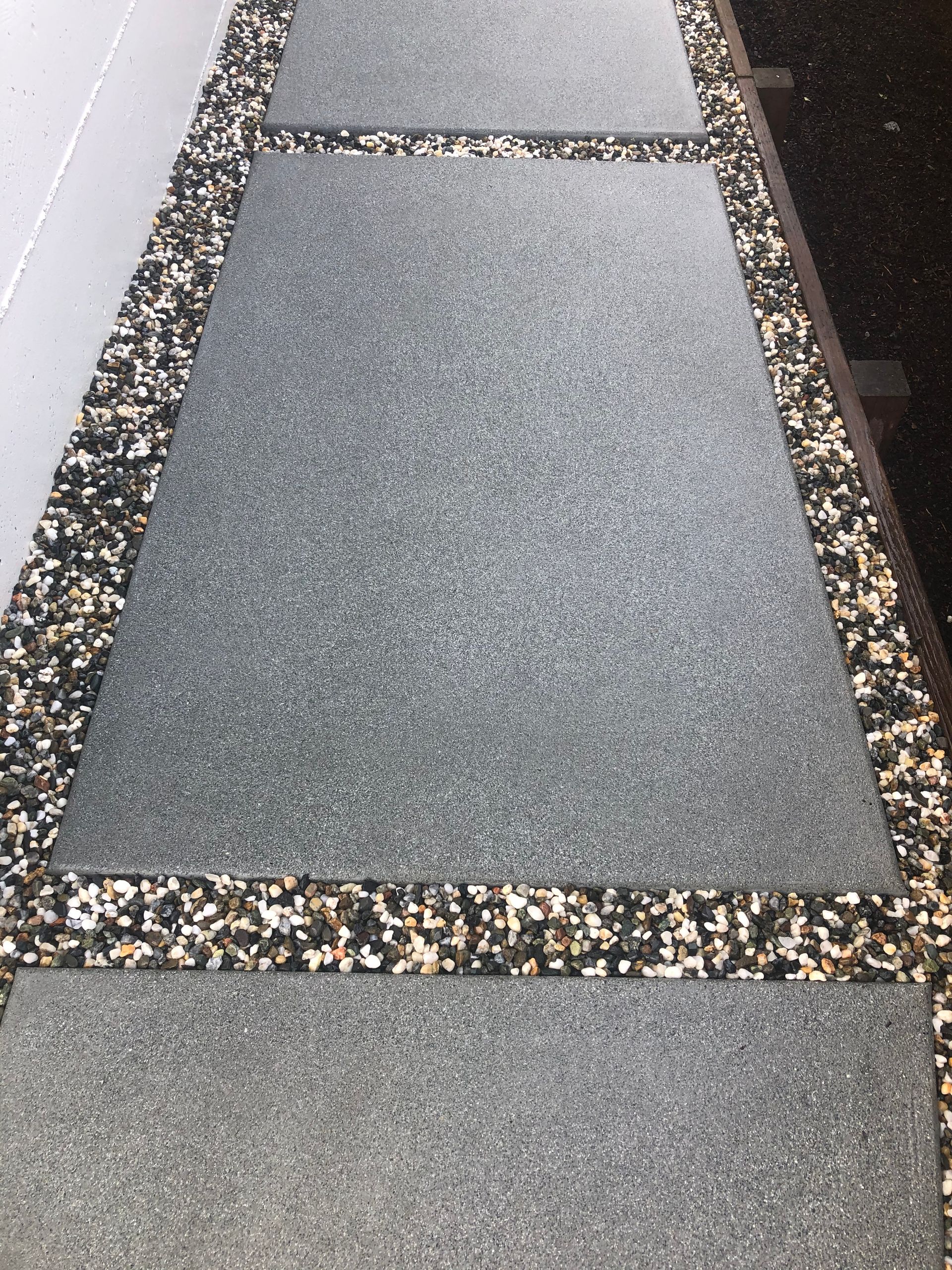 A man is leveling a concrete floor with a level.