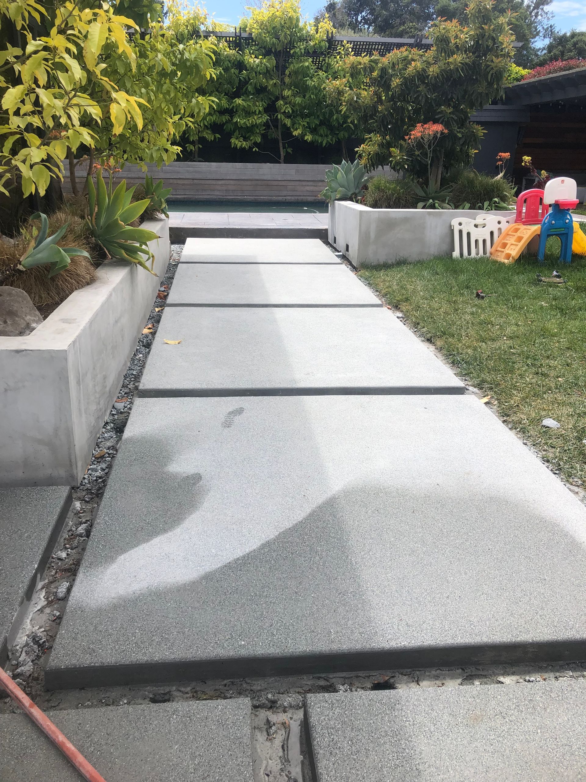 A group of construction workers are pouring concrete on a construction site.