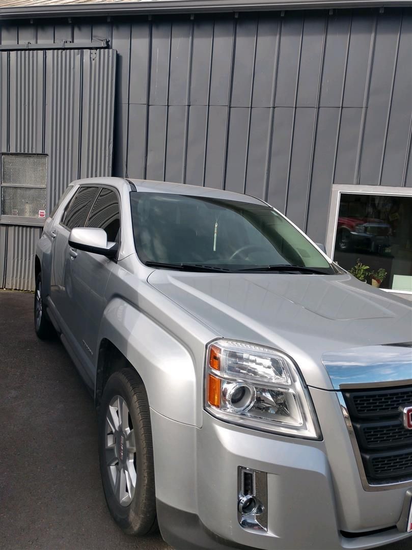 A silver suv is parked in front of a building. | J&H Automotive