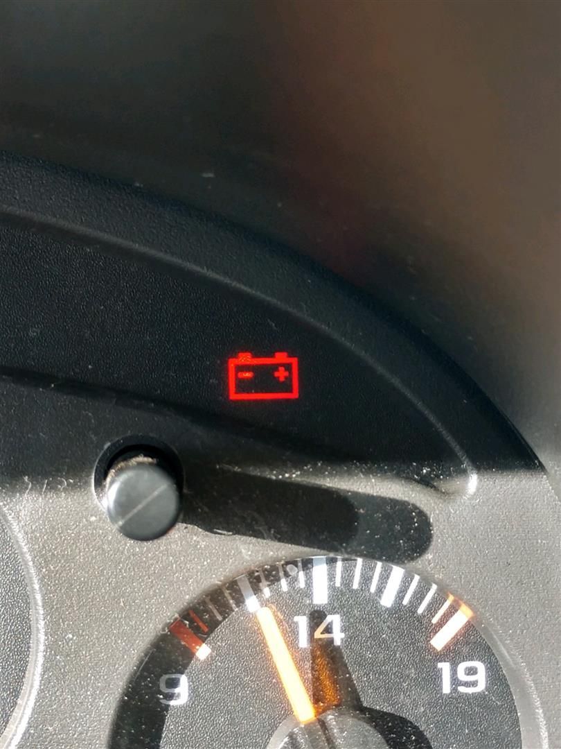 A close up of a dashboard with a red battery icon on it. | J&H Automotive