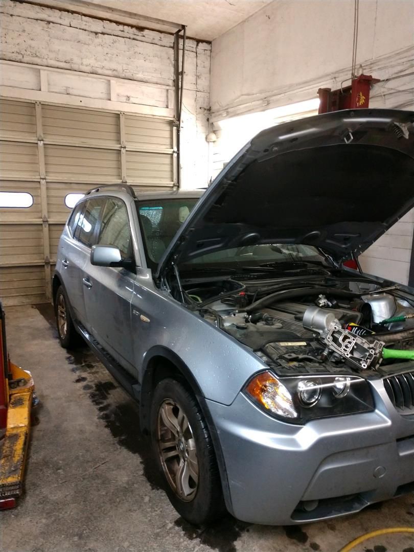 A silver car with the hood up in a garage | J&H Automotive