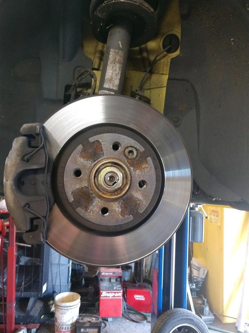 A close up of a brake disc on a car | J&H Automotive