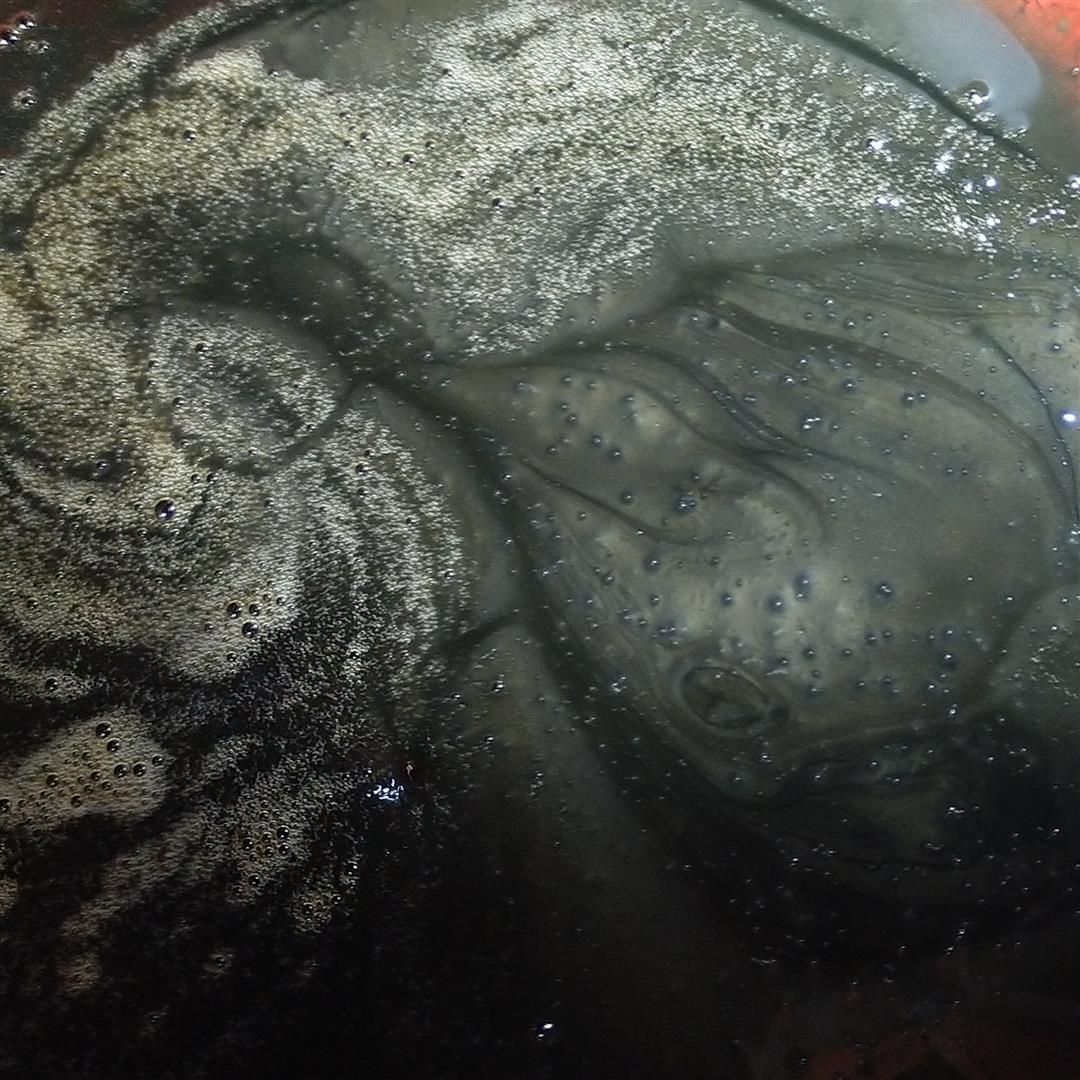 A close up of a rock in the water with bubbles coming out of it. | J&H Automotive