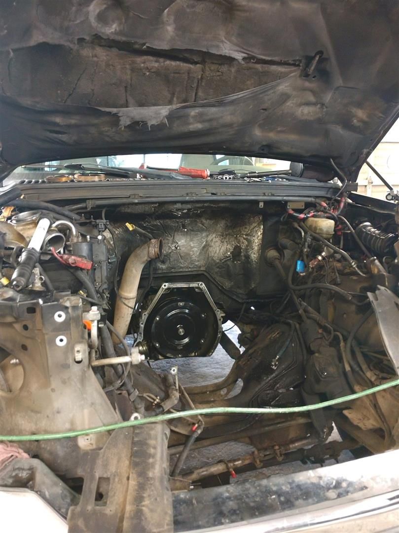 The engine of a car is being removed from the vehicle. | J&H Automotive