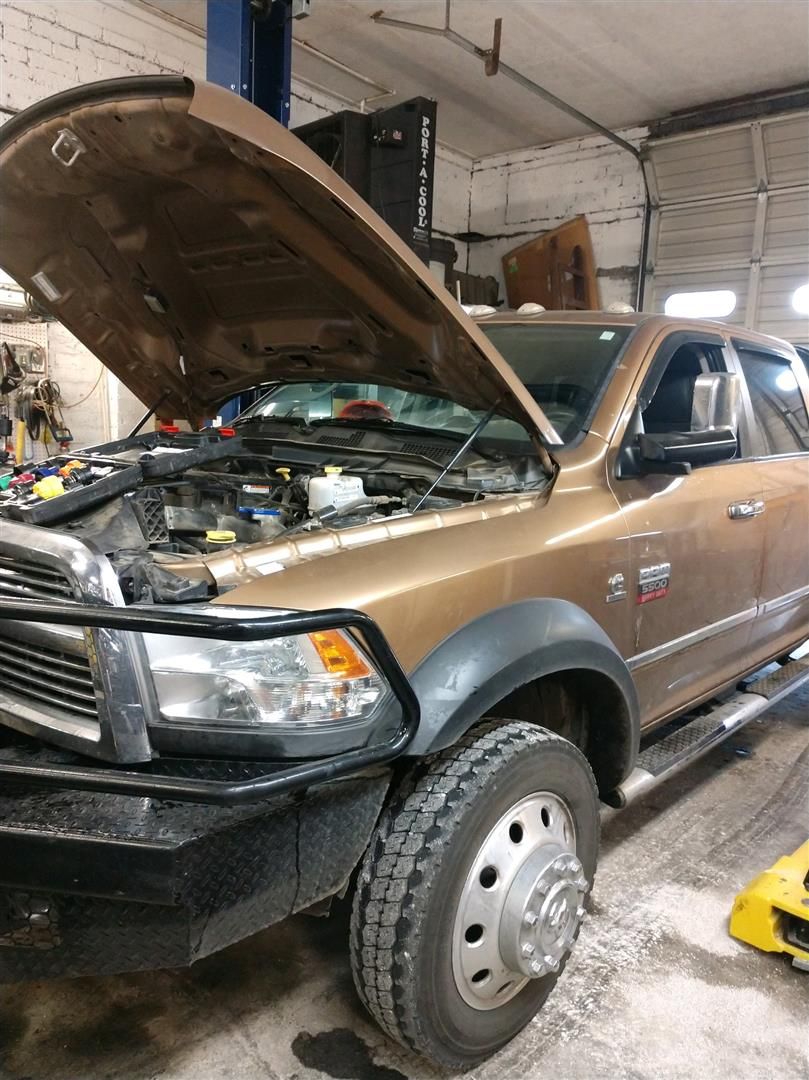 A truck with the hood up is parked in a garage. | J&H Automotive