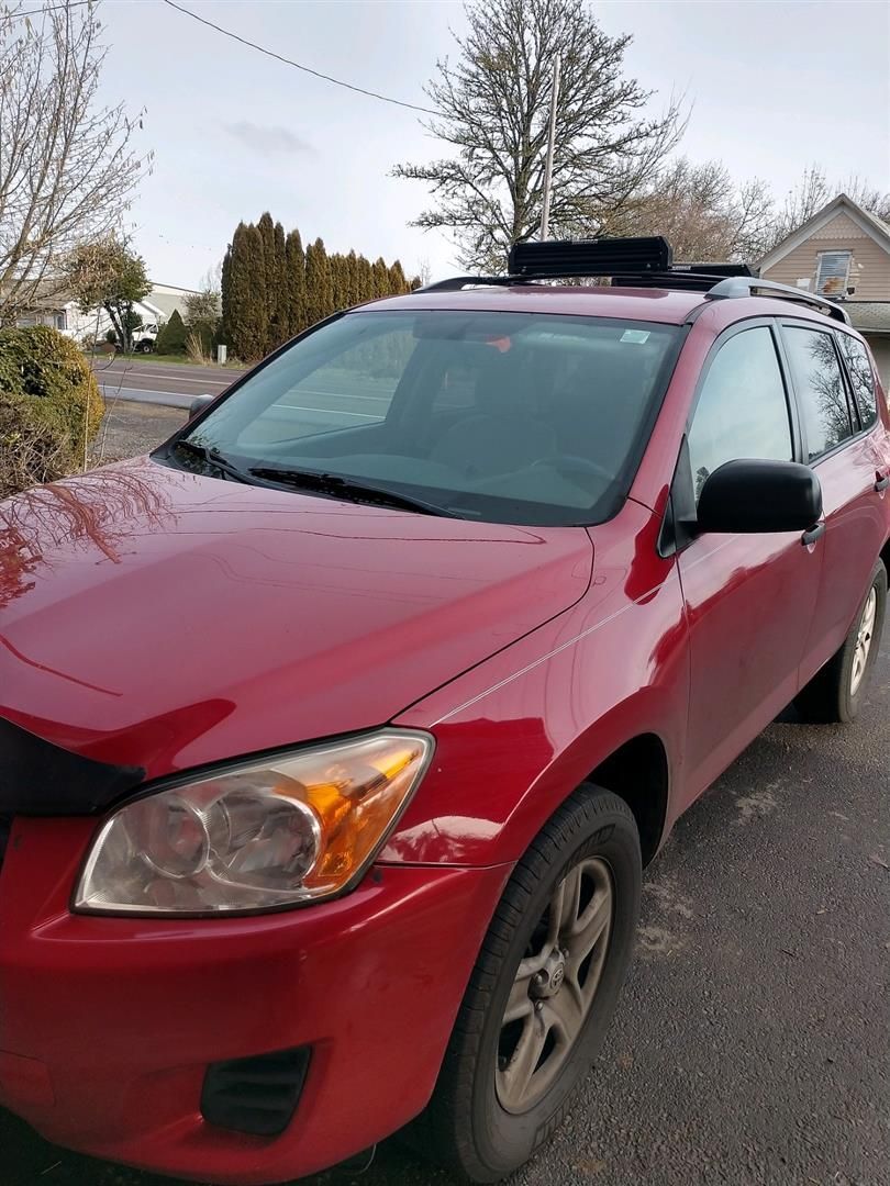 A red car is parked on the side of the road. | J&H Automotive