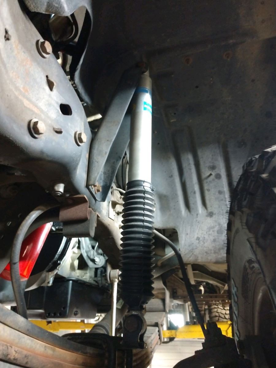 A close up of a shock absorber on a car | J&H Automotive