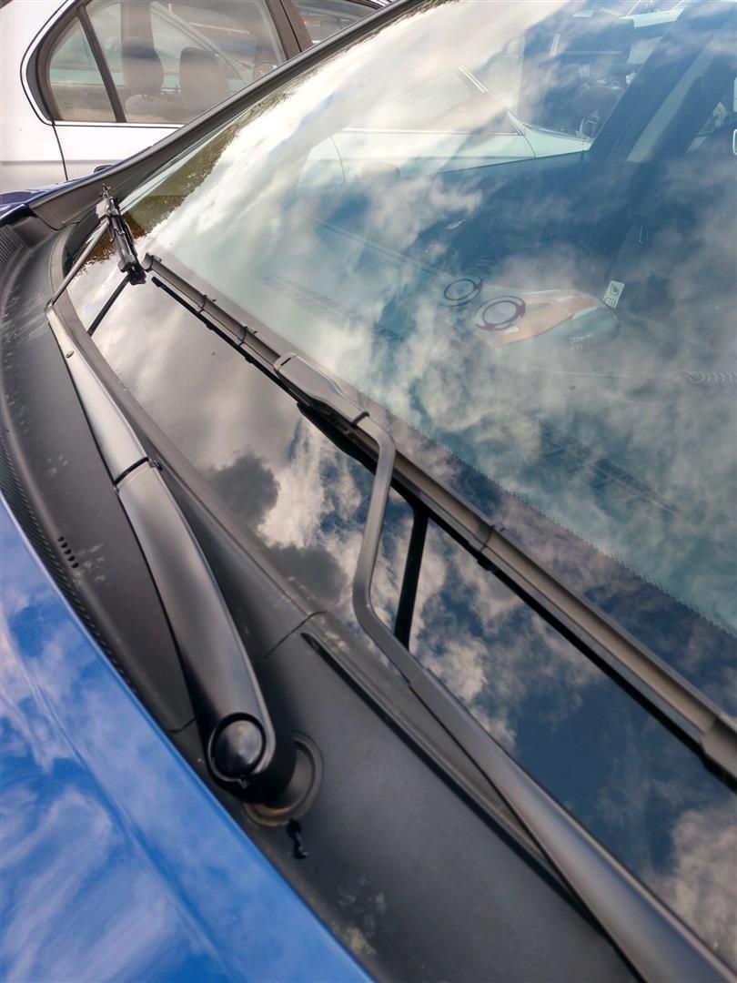 A close up of the windshield of a blue car | J&H Automotive