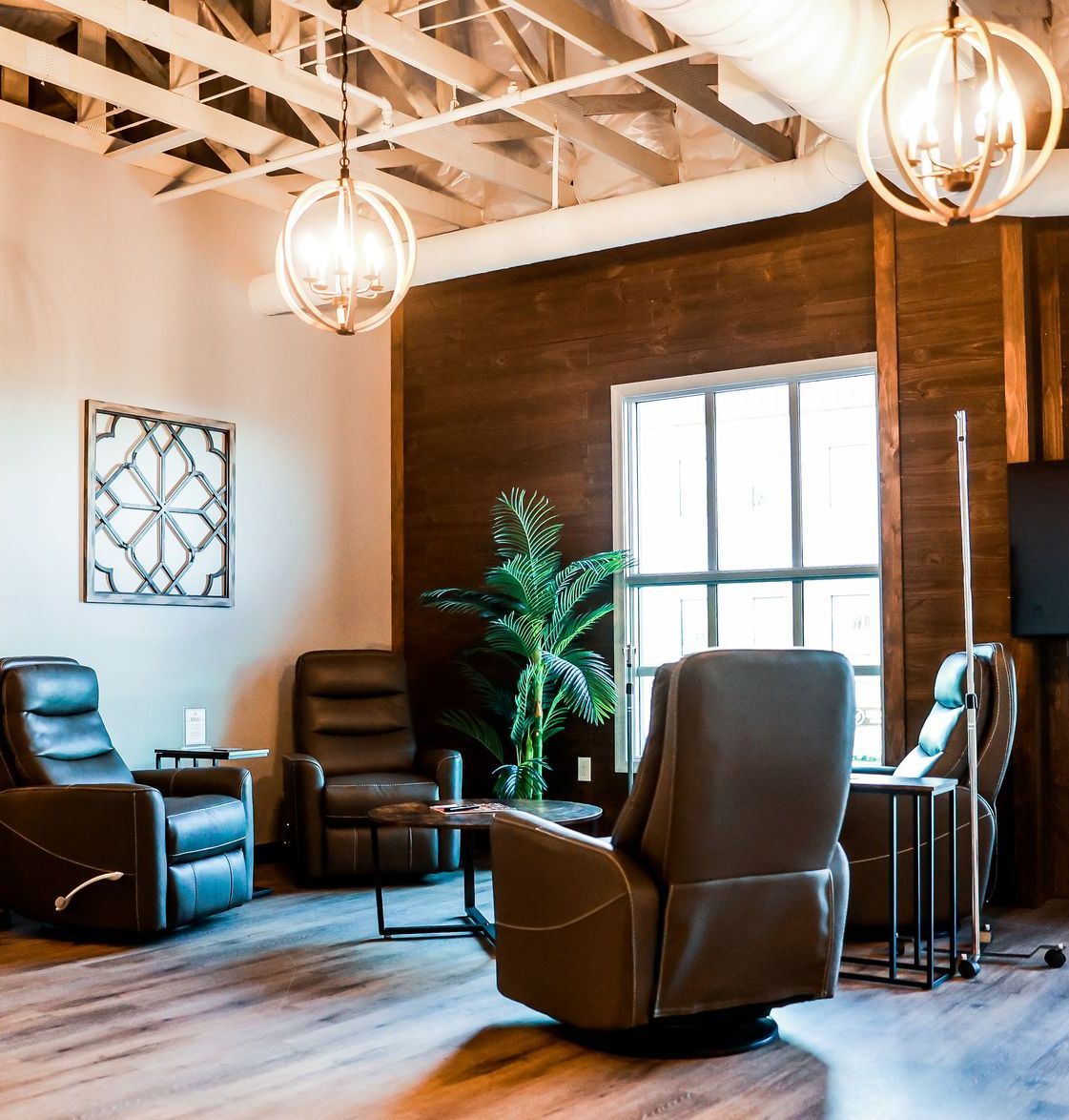 A woman is throwing leaves in the air in a park.