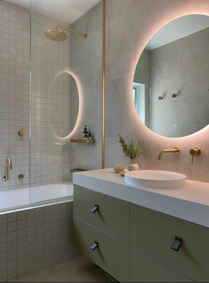 A bathroom with a sink , mirror and bathtub.