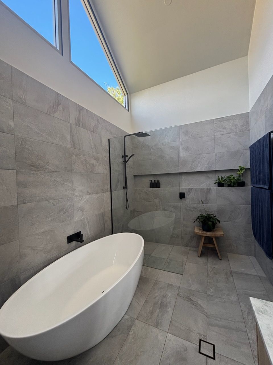 A bathroom with a bathtub and a walk in shower.