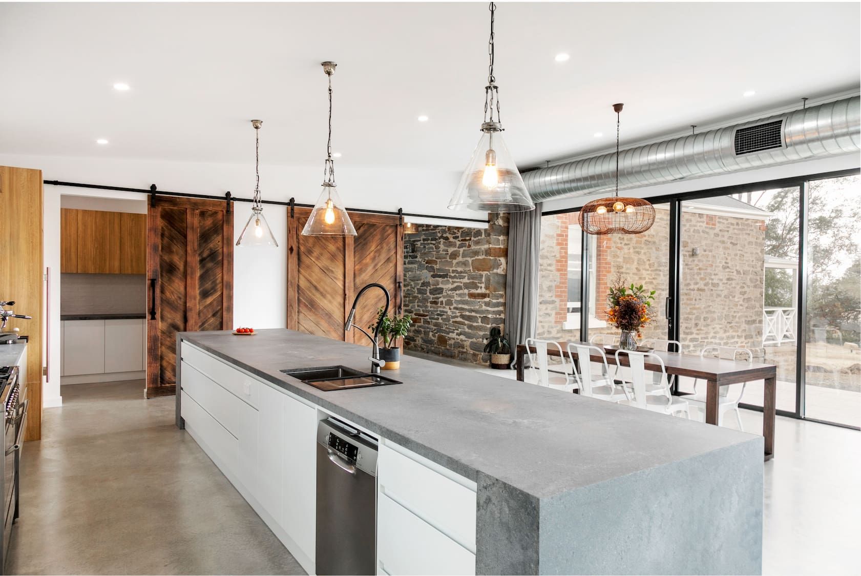 A kitchen with a large island and sliding glass doors.