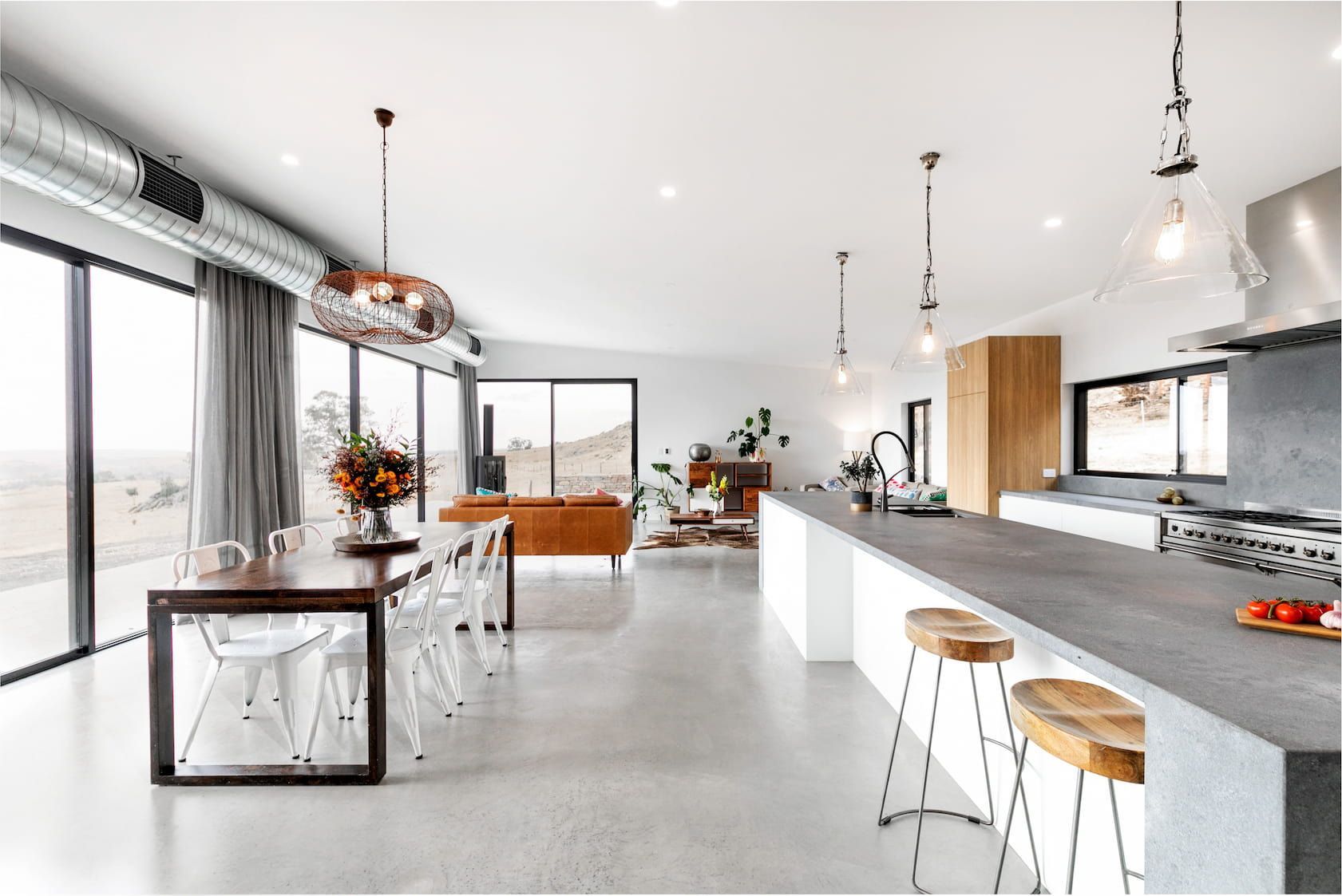 There is a table and chairs in the middle of the room.