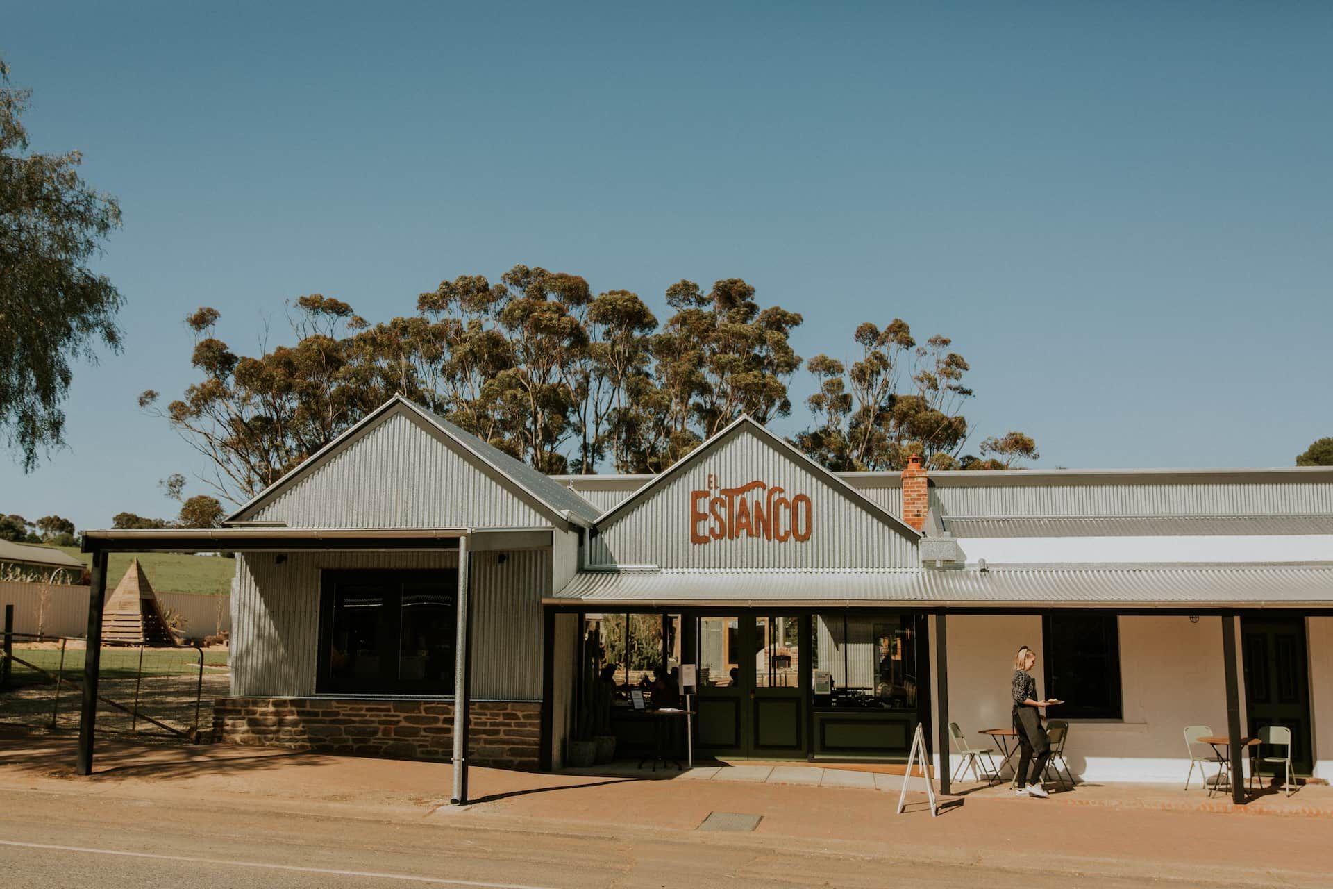 A man and a child are standing in front of a building.
