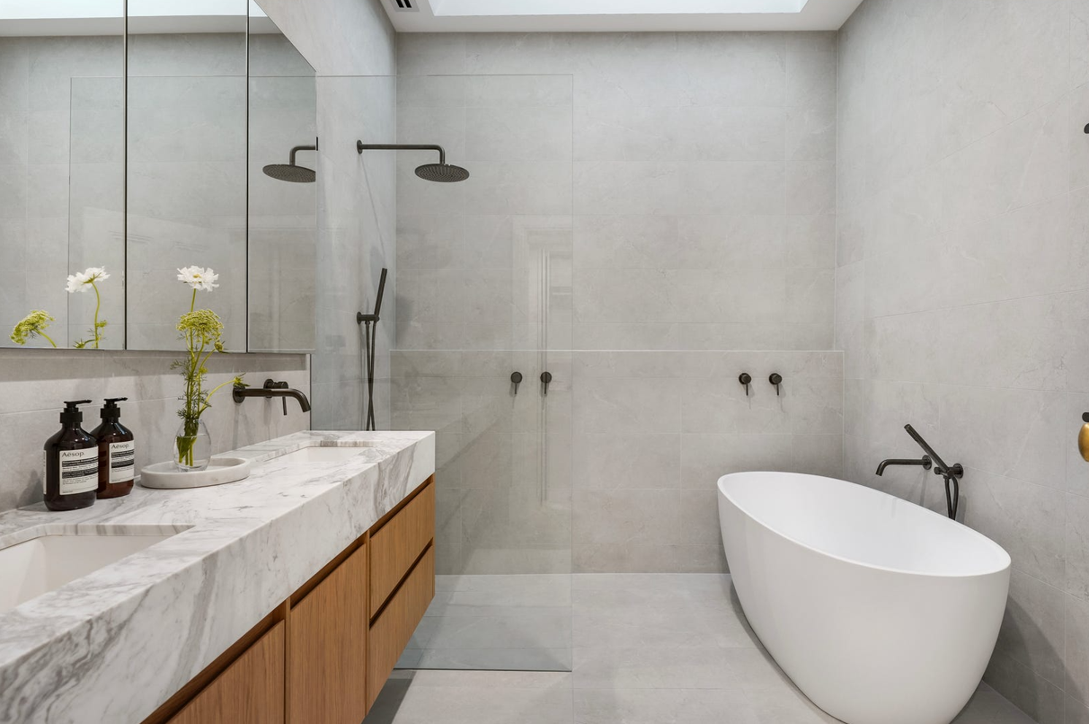 A bathroom with a bathtub and a walk in shower.