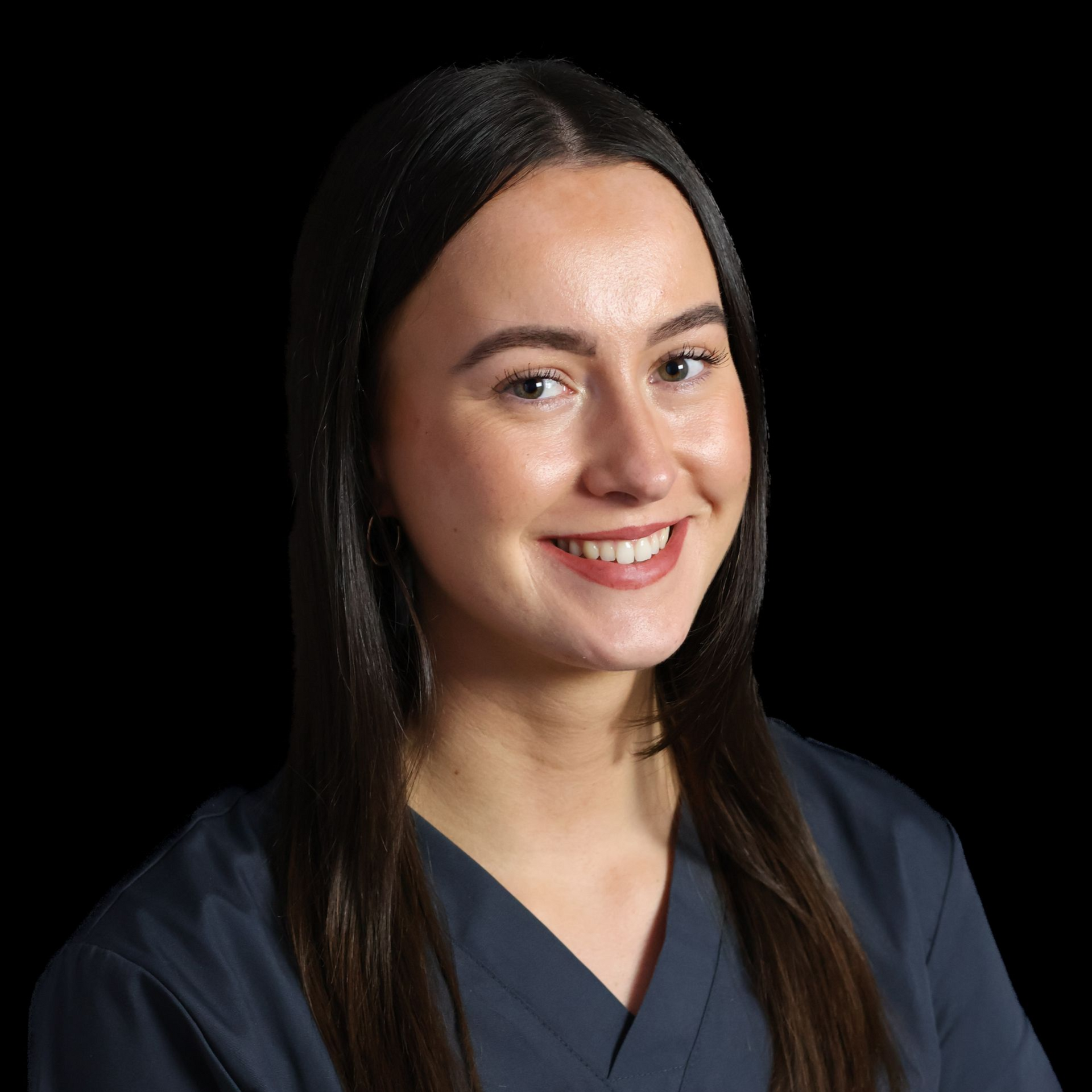 a woman dentist In a grey scrub top smiling 