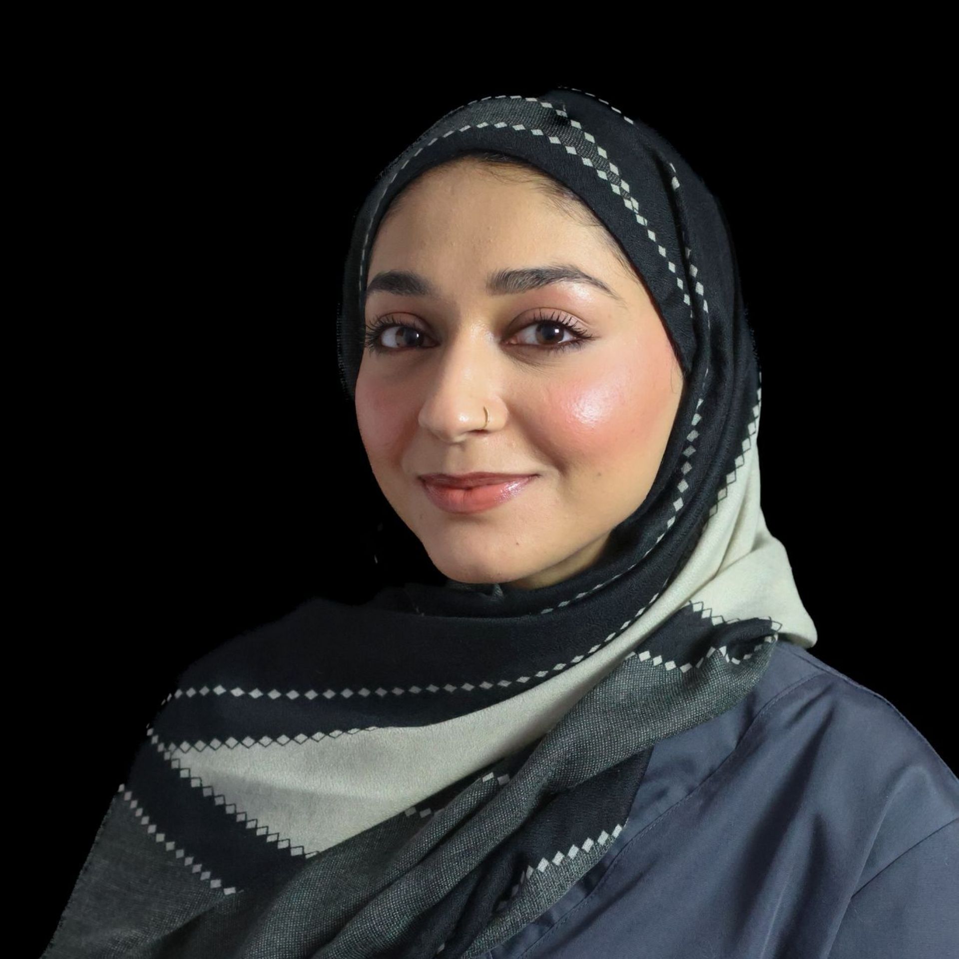 a woman dentist In a grey scrub top smiling