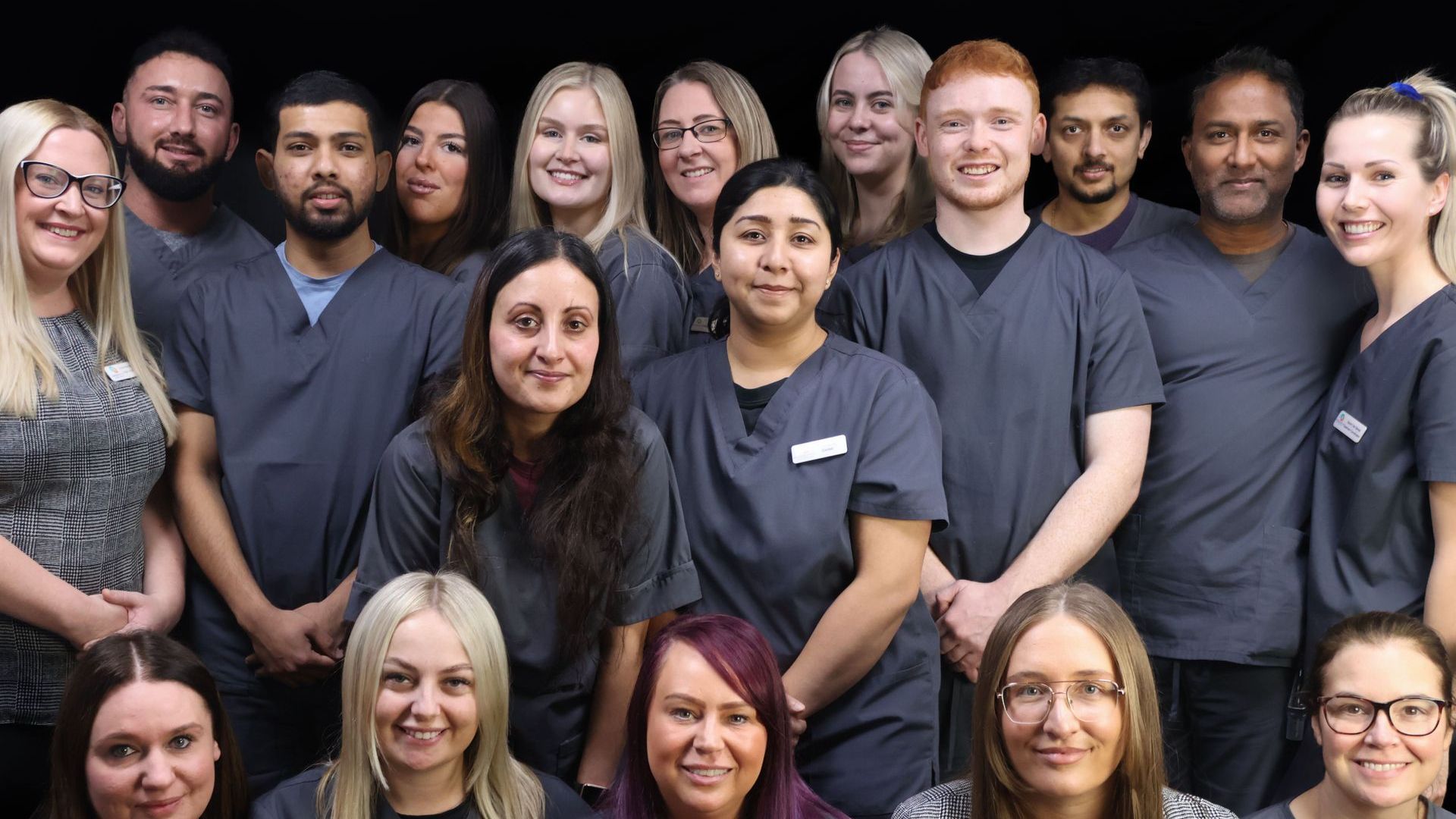 A group of people in scrubs are posing for a picture. Dental professionals. 