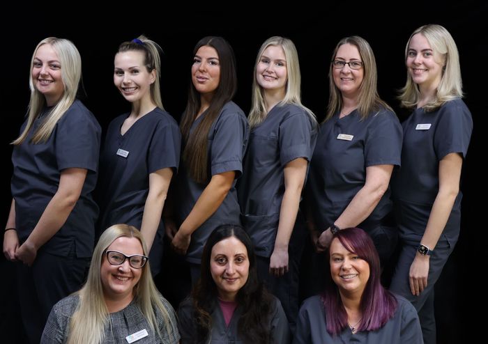 A group of women in scrubs are posing for a picture.