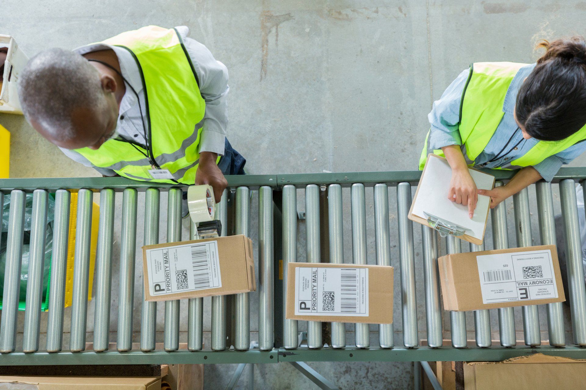 Workers in high vis labelling boxes