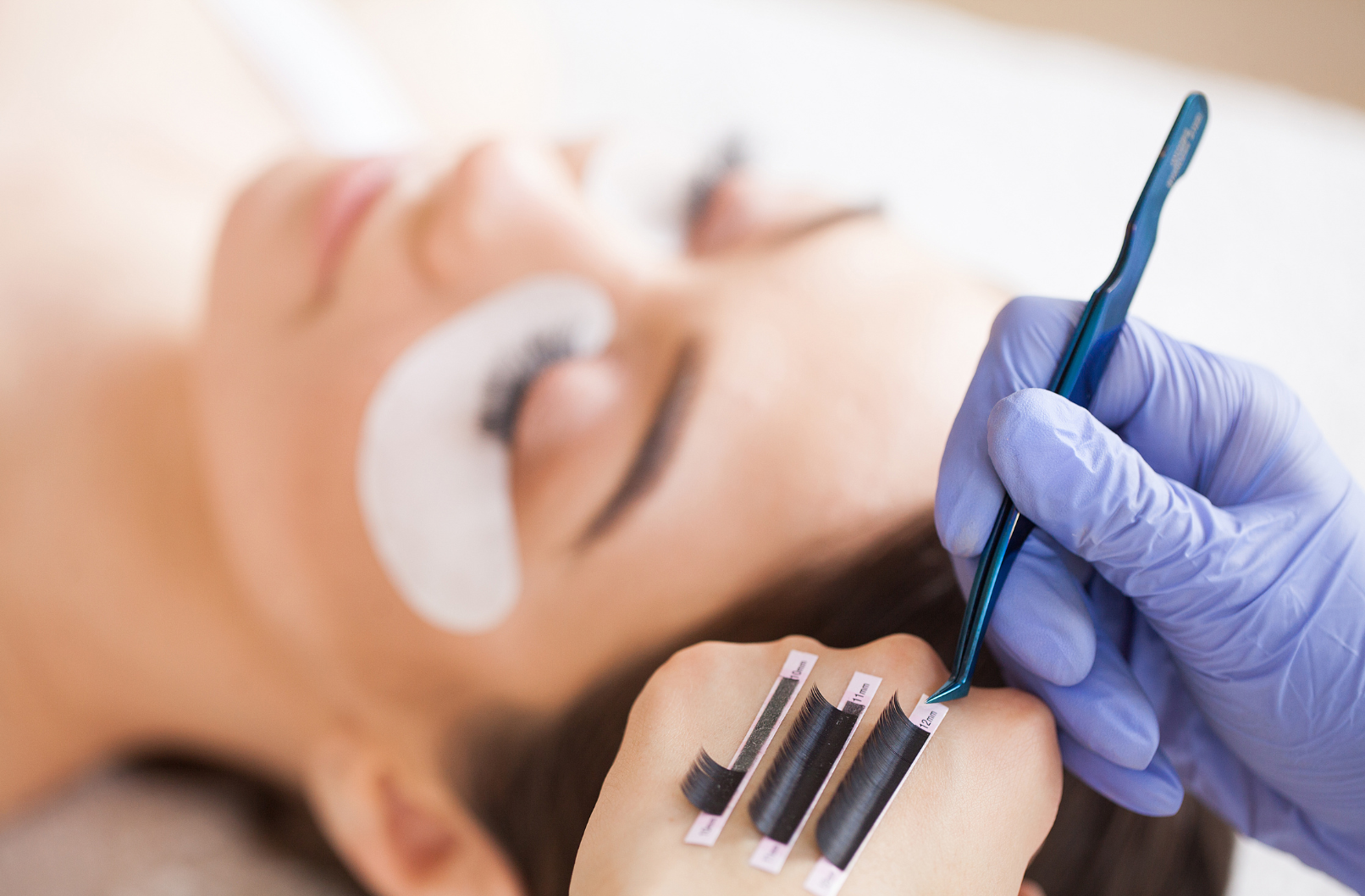 A woman is getting her eyelashes done at a beauty salon.
