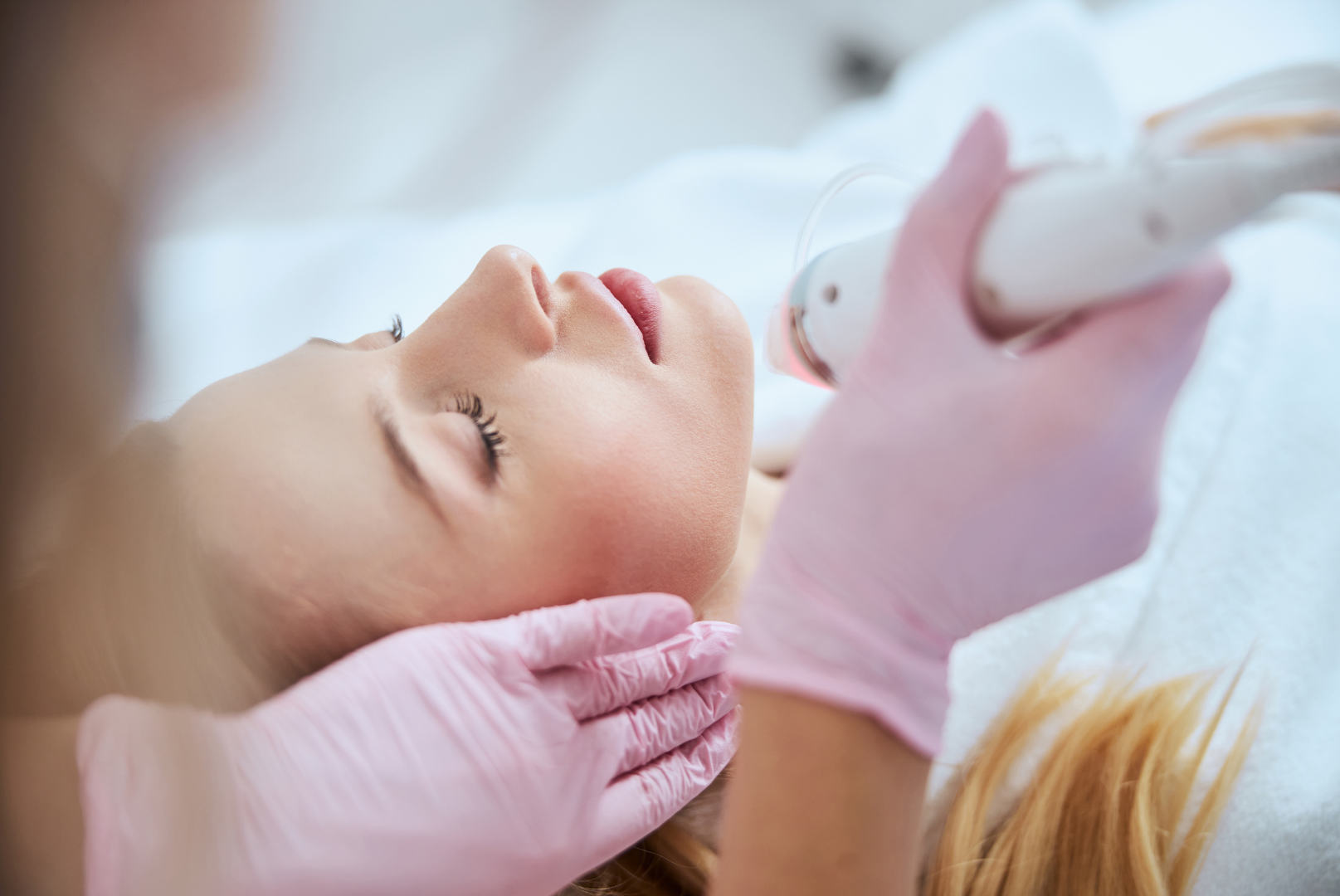 A woman is getting a facial treatment at a beauty salon.