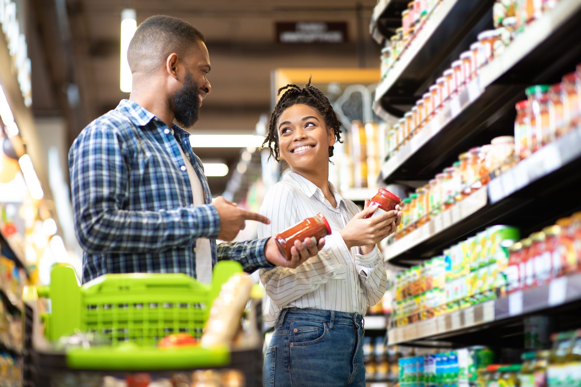 Man and woman talking to one another while grocery shopping