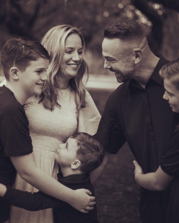 a black and white photo of a family posing for a picture