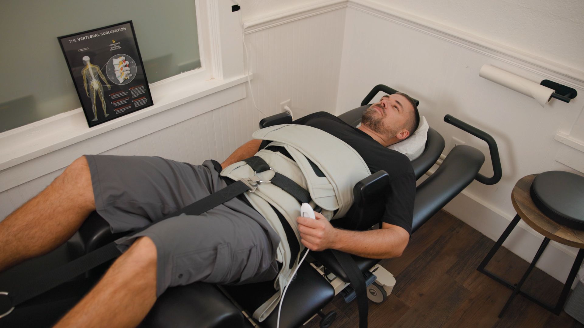 Man receiving spinal decompression therapy in a medical office.