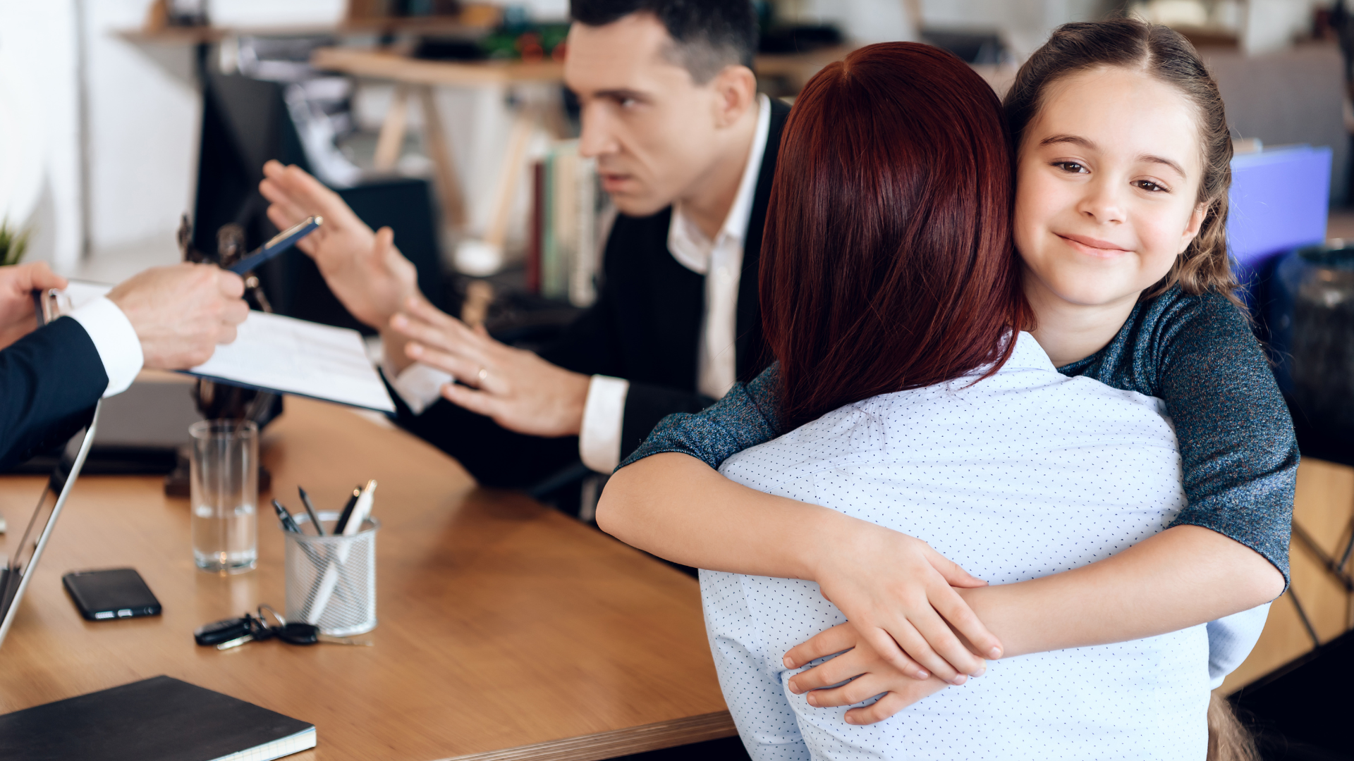 A man in a suit and tie is sitting at a table with a judge 's gavel and scales of justice.