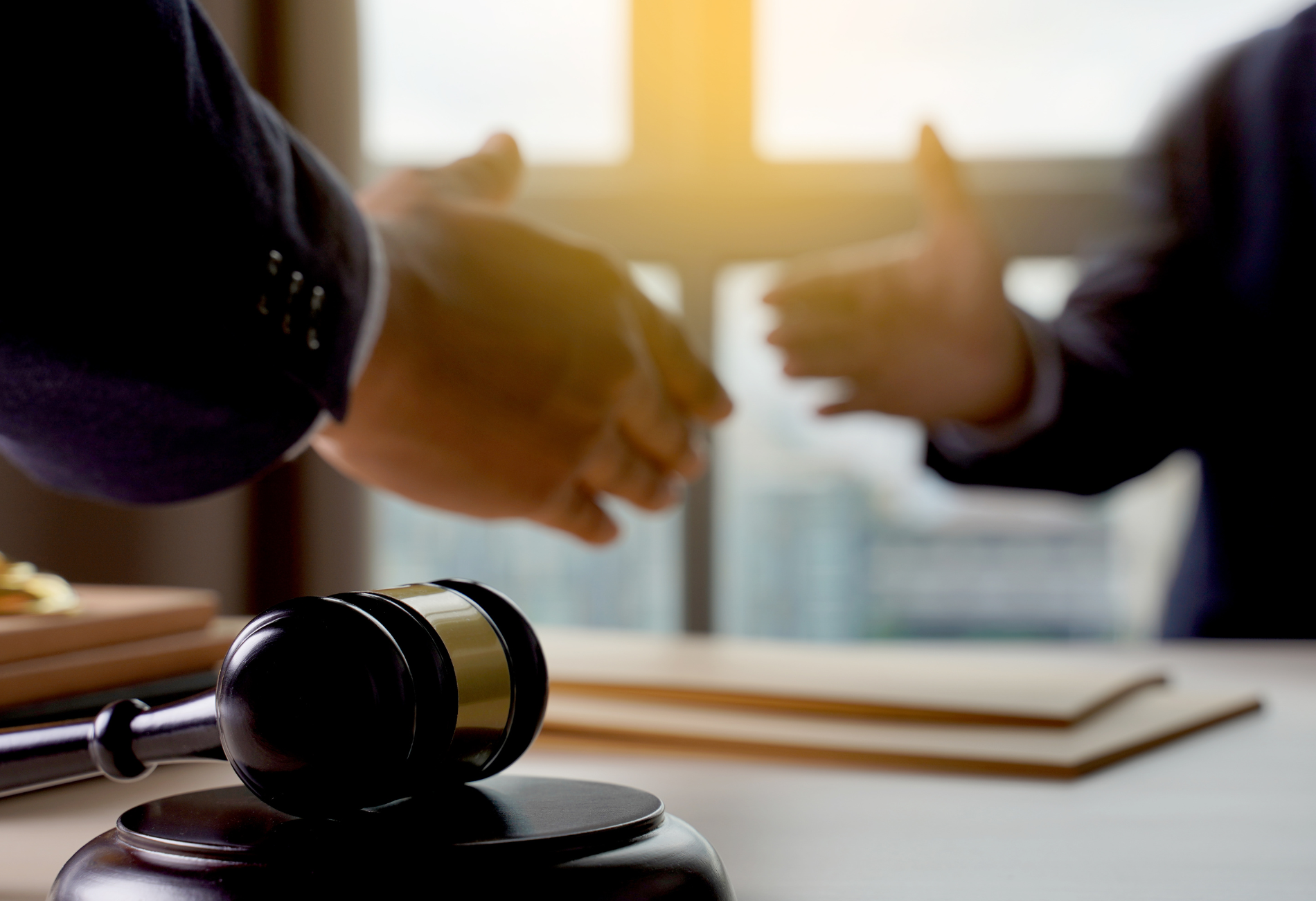 A lawyer is sitting at a desk writing on a clipboard.