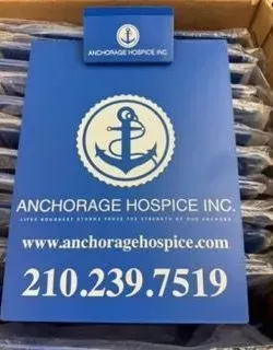 Blue clipboard with Anchorage Hospice Inc. logo, website, and phone number.