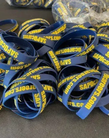 Pile of dark blue wristbands with yellow text: SAPcareers.com.