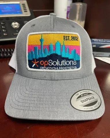 Gray baseball cap with a patch depicting a city skyline and