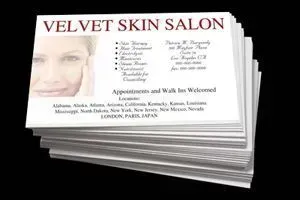 Stack of business cards for Velvet Skin Salon; a woman's blurred face appears on the cards.