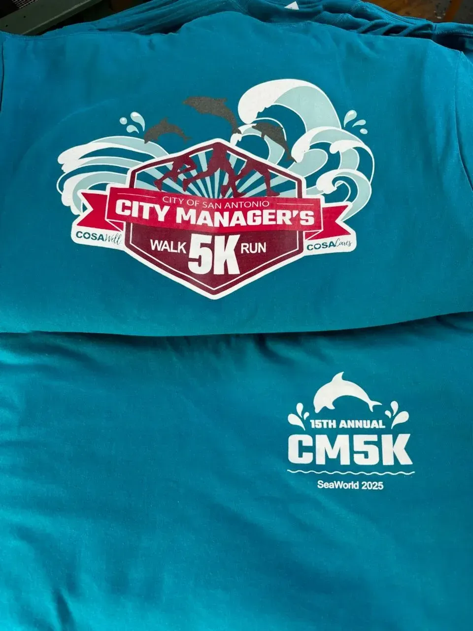 Two turquoise shirts with