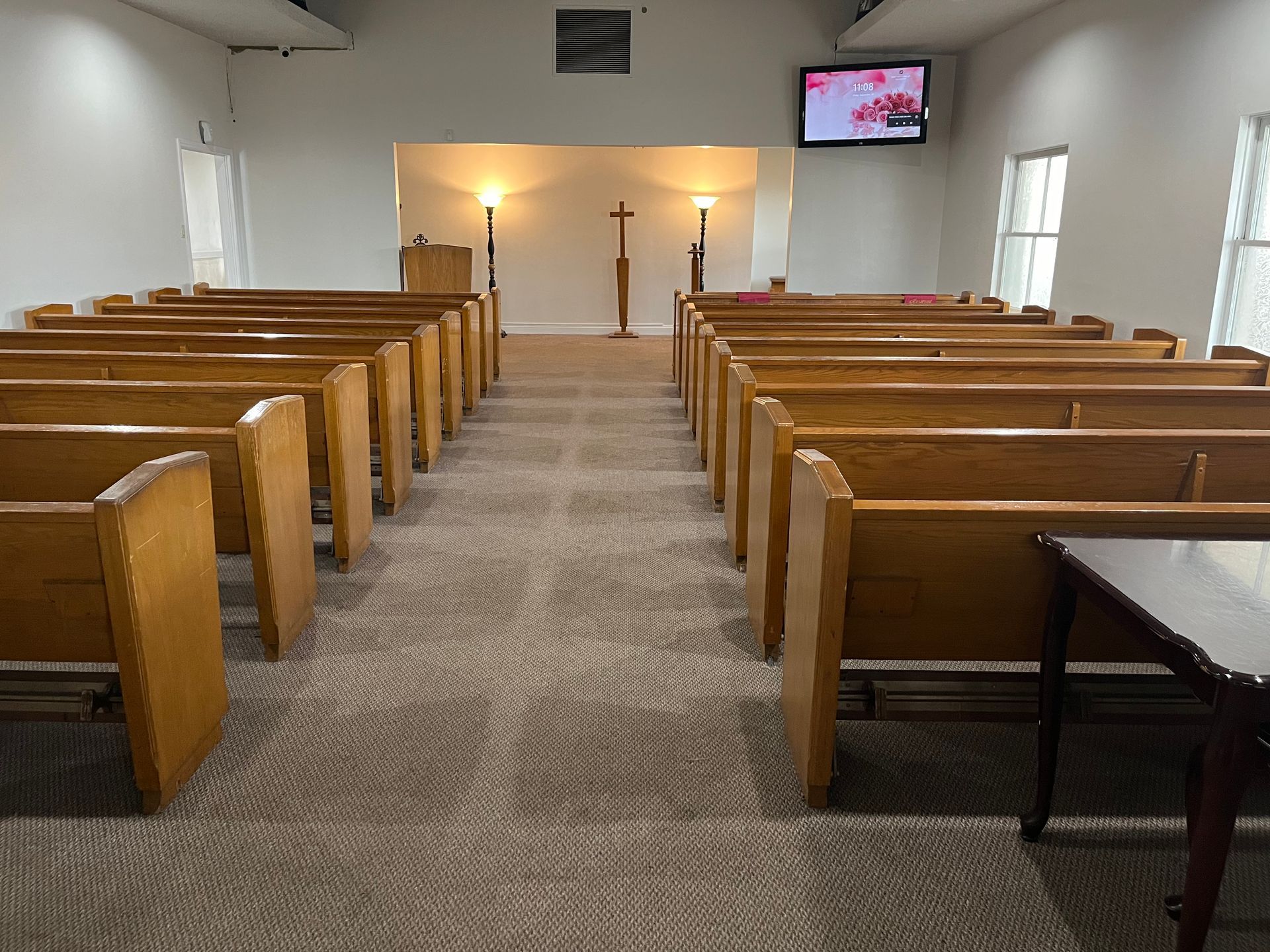 interior of the chapel with lots of blue seats and photos