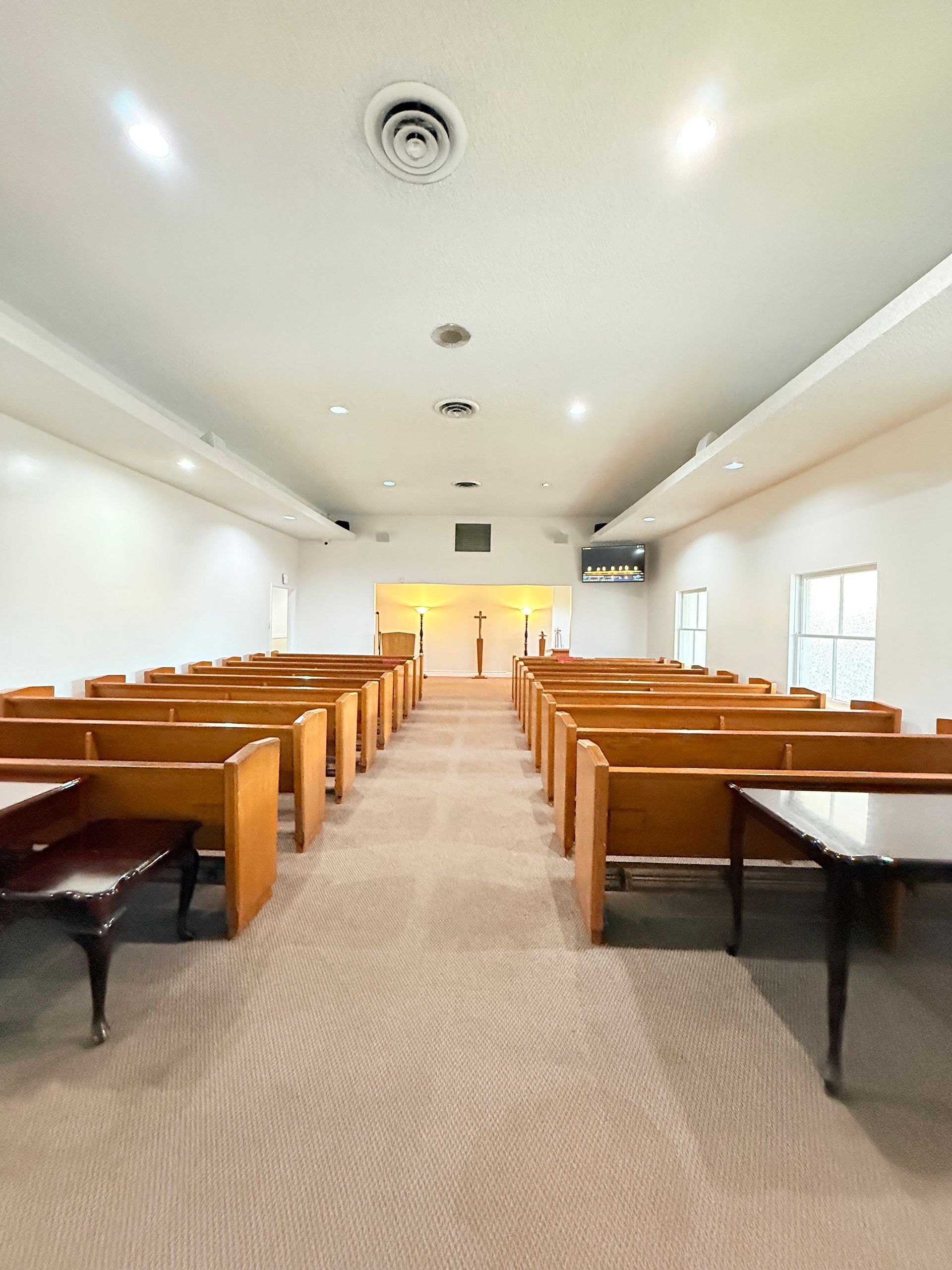 interior of the chapel with lots of blue seats and photos