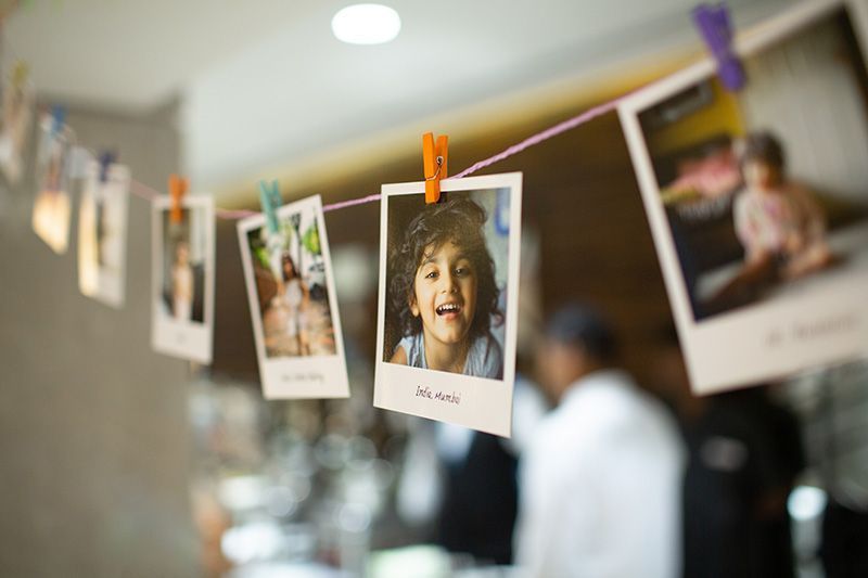 A string of polaroid pictures hanging on a clothesline.