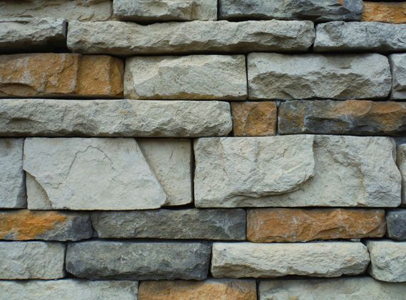 A close up of a brick wall made of different colored bricks