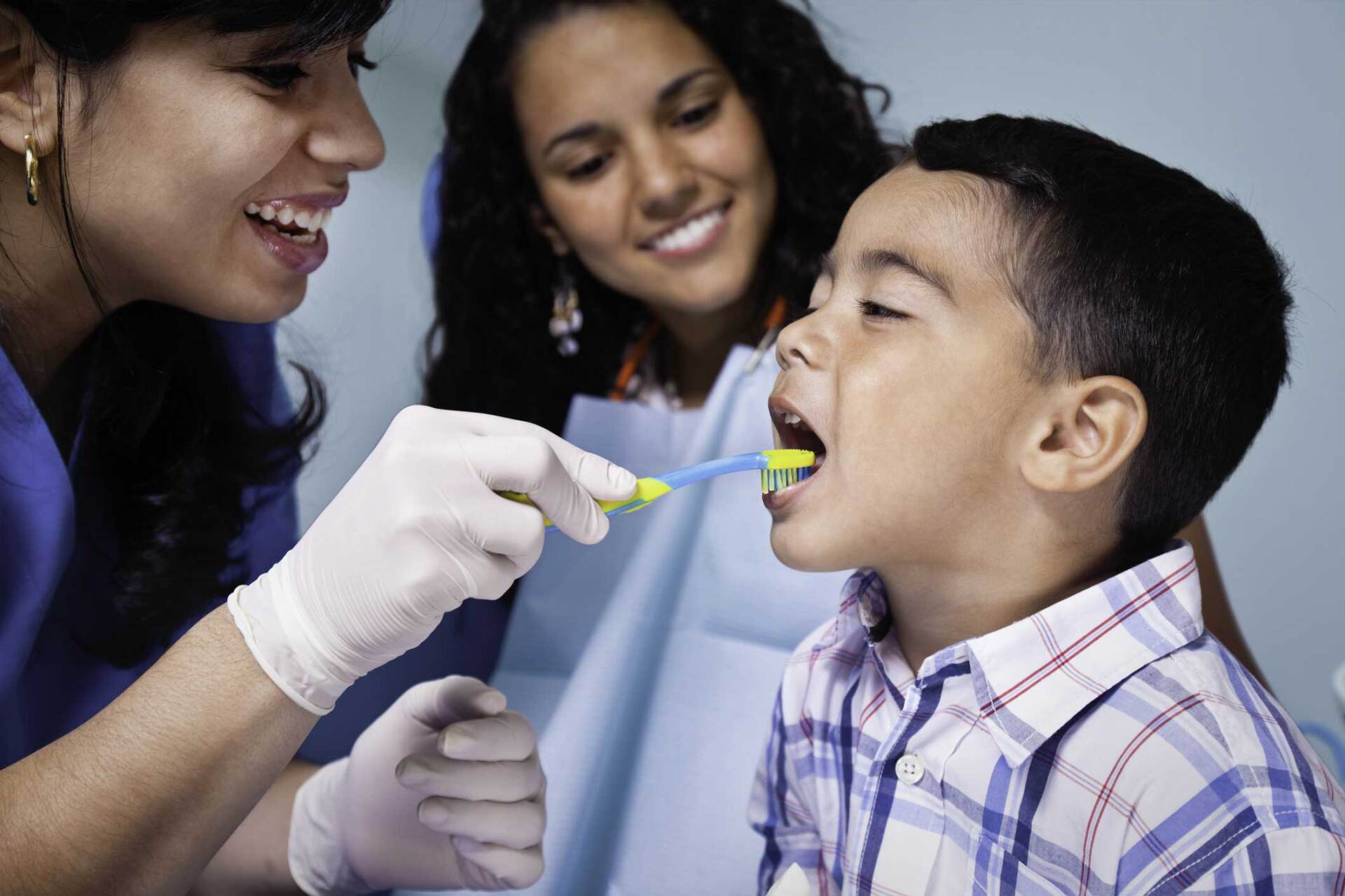 Dentist Teaching Toothbrush Use to Child Patient — Largo, FL — Mid County Dental Associates