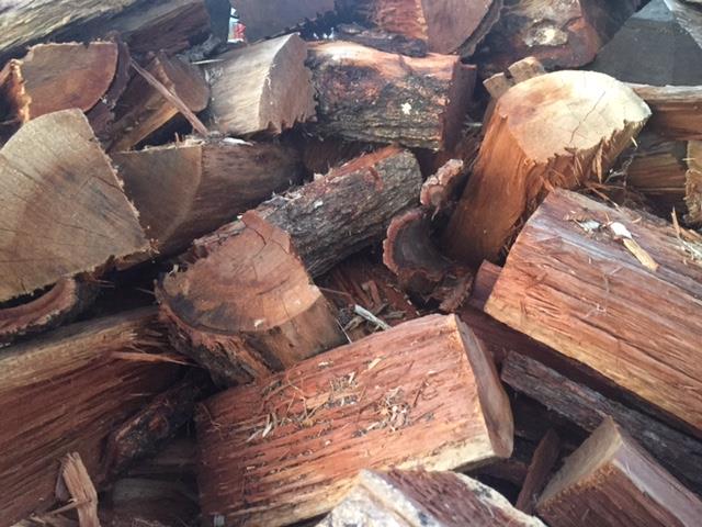 A Pile Of Wood Is Sitting On Top Of Each Other — Brown's Professional Tree Service In Pie Creek, QLD